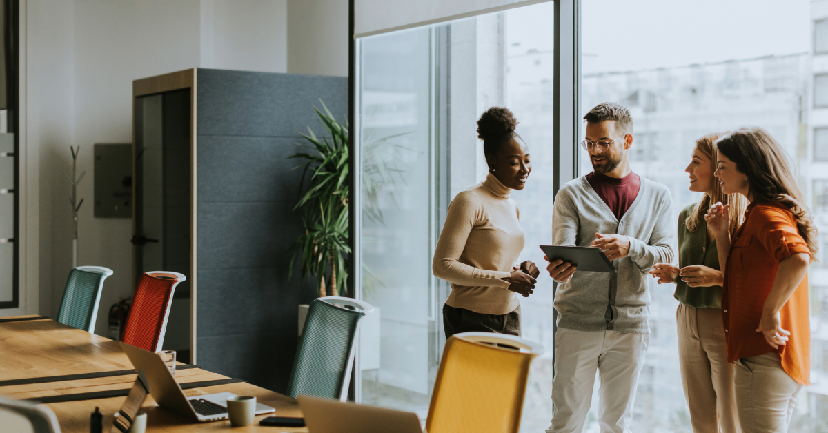 grupo de personas hablando de pie en una oficina